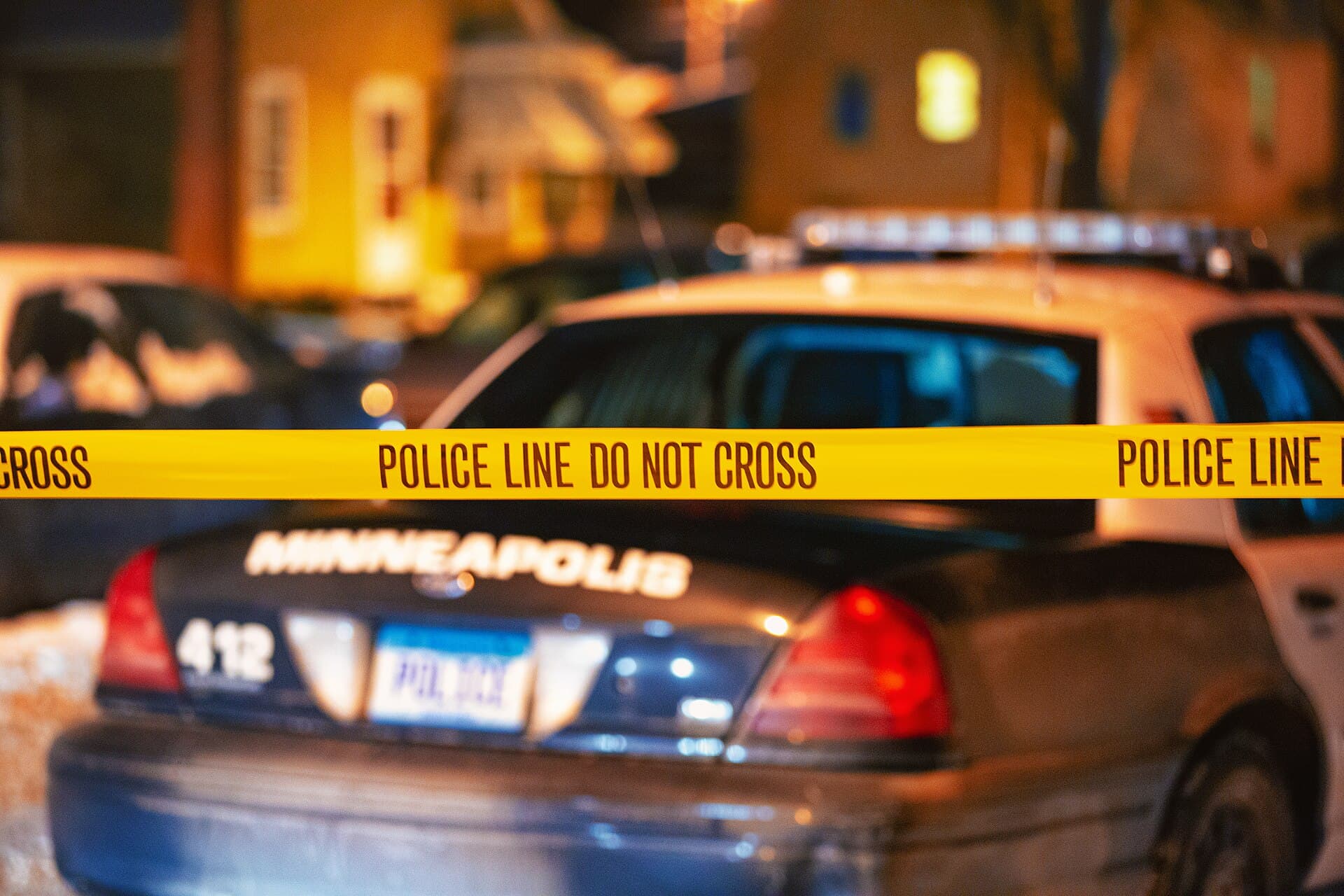 Police crime scene tape reading 'Police Line Do Not Cross' from the Minneapolis Police Department.